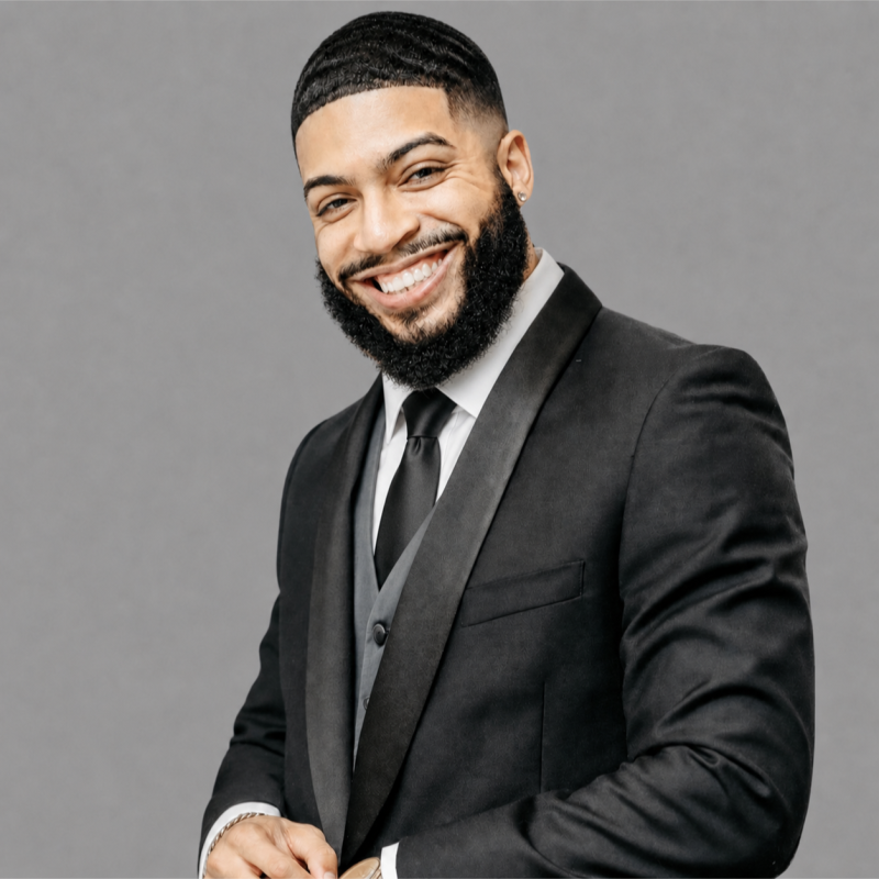 Jeremy Rodriguez in a black suit and tie